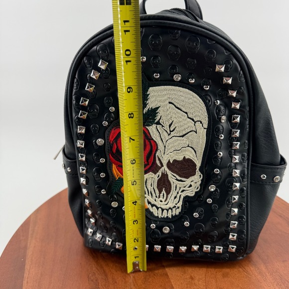 black leather skull backpack purse SandraWang ‌Gothic Studded for Women & Men, Structured PU Punk Bookbag with Drawstring Flap, A4 & Tablet Friendly Alternative Fashion Design: Clothing, Shoes & Jewelry The front of this purse is decorated with a bright day of the dead design Experience the power of the